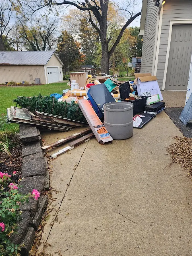 Dumpster being loaded with debris for Estate Cleanout Dumpster Rental in Canton